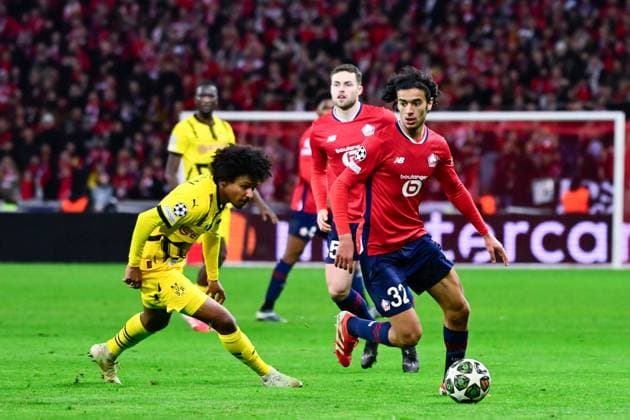 FOOTBALL : Lille vs Borussia Dortmund - Ligue des Champions - 12 03 2025 Ayyoub BOUADDI ( 32 - Lille ) and Karim Adeyemi ( 27 - Borussia Dortmund ) during UEFA Champions League match between Lille OSC and Borussia Dortmund at Stade Pierre Mauroy on March 12, 2025 in Lille, France. ( Photo by Dante Badano PsnewZ ) - LilleFrance  Copyright: xDantexBadanox