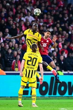 FOOTBALL : Lille vs Borussia Dortmund - Ligue des Champions - 12 03 2025 Benjamin Andre ( 21 - Lille ) and Karim Adeyemi ( 27 - Borussia Dortmund ) during UEFA Champions League match between Lille OSC and Borussia Dortmund at Stade Pierre Mauroy on March 12, 2025 in Lille, France. ( Photo by Dante Badano PsnewZ ) - LilleFrance  Copyright: xDantexBadanox