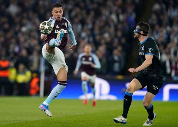 Birmingham, England, 12th March 2025. Morgan Rogers of Aston Villa controls the ball ahead of Brandon Mechele of Club Brugge during the UEFA Champions League match Aston Villa v Club Brugge at Villa Park, Birmingham. Picture credit should read: Andrew Yates Sportimage EDITORIAL USE ONLY. No use with unauthorised audio, video, data, fixture lists, club league logos or live services. Online in-match use limited to 120 images, no video emulation. No use in betting, games or single club league player publications. SPI_020_AY_Villa_Brugge SPI-3740-0020
