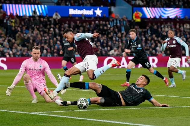 Birmingham, England, 12th March 2025. Jacob Ramsey of Aston Villa is tackled by Zaid Romero of Club Brugge during the UEFA Champions League match Aston Villa v Club Brugge at Villa Park, Birmingham. Picture credit should read: Andrew Yates Sportimage EDITORIAL USE ONLY. No use with unauthorised audio, video, data, fixture lists, club league logos or live services. Online in-match use limited to 120 images, no video emulation. No use in betting, games or single club league player publications. SPI_058_AY_Villa_Brugge SPI-3740-0058