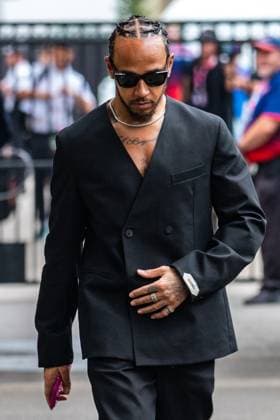 March 13, 2025, Melbourne, Victoria, Australia: Scuderia Ferrari HP driver LEWIS HAMILTON of United Kingdom enters the paddock in a stylish black suit on Thursday at the Formula 1 Louis Vuitton Australian Grand Prix 2025 on March 13, 2025 in Melbourne, Australia. Melbourne Australia - ZUMAf186 20250313_zsp_f186_065 Copyright: xJamesxForresterx