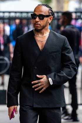 March 13, 2025, Melbourne, Victoria, Australia: Scuderia Ferrari HP driver LEWIS HAMILTON of United Kingdom enters the paddock in a stylish black suit on Thursday at the Formula 1 Louis Vuitton Australian Grand Prix 2025 on March 13, 2025 in Melbourne, Australia. Melbourne Australia - ZUMAf186 20250313_zsp_f186_071 Copyright: xJamesxForresterx