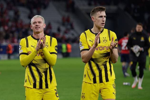 March 12, 2025, Villeneuve D ascq, France, Julian Ryerson Borussia Dortmund and Nico Schlotterbeck Borussia Dortmund applauds the fans after the match the UEFA Champions League match between OSC Lille and Borussia Dortmund Copyright: AntonioxBorga