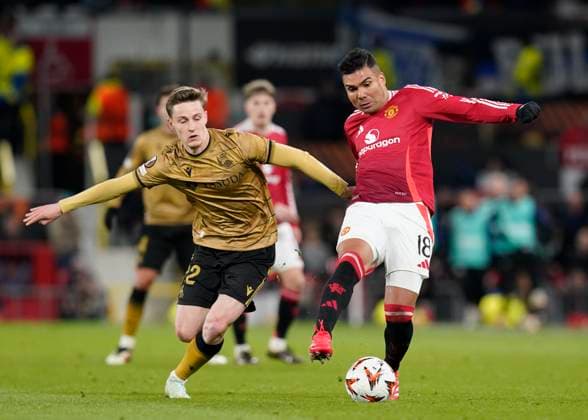 Manchester, England, 13th March 2025. Benat Turrientes of Real Sociedad tussles with Casemiro of Manchester United, ManU during the UEFA Europa League match Manchester United v Real Sociedad at Old Trafford, Manchester. Picture credit should read: Andrew Yates Sportimage EDITORIAL USE ONLY. No use with unauthorised audio, video, data, fixture lists, club league logos or live services. Online in-match use limited to 120 images, no video emulation. No use in betting, games or single club league player publications. SPI_064_AY_MANU_SOCIEDAD SPI-3744-0067