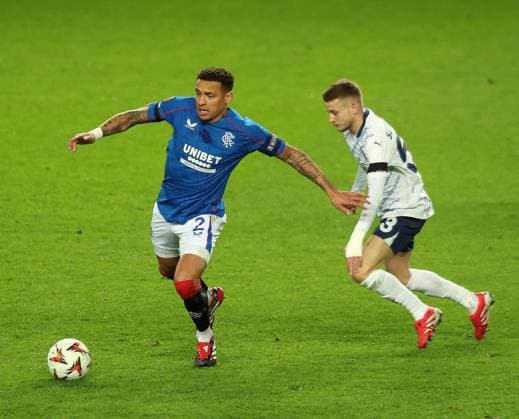 James Tavernier of Rangers in action with Sebastian Szymanski of Fenerbahce during the UEFA Europa League round of 16 match at Ibrox Stadium, Glasgow. Rangers v Fenerbahce, UEFA Europa League, Round of 16, Second Leg, Football, Ibrox Stadium, Glasgow, Scotland, UK - 13 Mar 2025 EDITORIAL USE ONLY No use with unauthorised audio, video, data, fixture lists, club league logos or live services. Online in-match use limited to 120 images, no video emulation. No use in betting, games or single club league player publications. Copyright: xRangersxFC Shutterstockx 15196581g