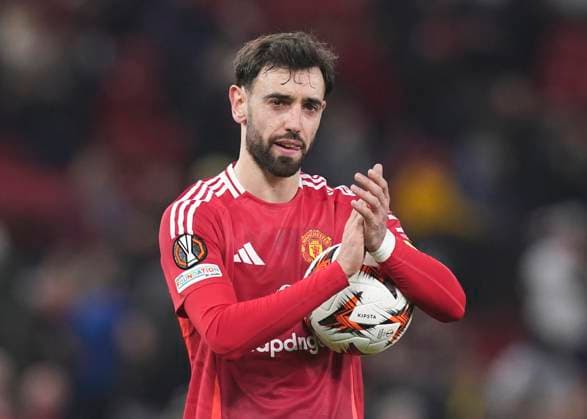 Manchester, England, 13th March 2025. Bruno Fernandes of Manchester United, ManU with the match ball after scoring a hat trick during the UEFA Europa League match Manchester United v Real Sociedad at Old Trafford, Manchester. Picture credit should read: Andrew Yates Sportimage EDITORIAL USE ONLY. No use with unauthorised audio, video, data, fixture lists, club league logos or live services. Online in-match use limited to 120 images, no video emulation. No use in betting, games or single club league player publications. SPI_074_AY_MANU_SOCIEDAD SPI-3744-0077