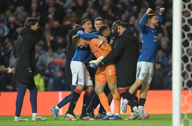 Glasgow, Scotland, 13th March 2025. Jack Butland of Rangers is mobbed by teammates after the penalty shoot out during the UEFA Europa League match Rangers v Fenerbahce at Ibrox Stadium, Glasgow. Picture credit should read: Neil Hanna Sportimage EDITORIAL USE ONLY. No use with unauthorised audio, video, data, fixture lists, club league logos or live services. Online in-match use limited to 120 images, no video emulation. No use in betting, games or single club league player publications. SPI_025_NH_Rangers_Fenerbahc__e SPI-3743-0025
