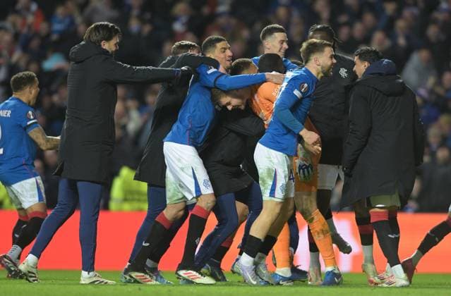 Glasgow, Scotland, 13th March 2025. Jack Butland of Rangers is mobbed by teammates after the penalty shoot out during the UEFA Europa League match Rangers v Fenerbahce at Ibrox Stadium, Glasgow. Picture credit should read: Neil Hanna Sportimage EDITORIAL USE ONLY. No use with unauthorised audio, video, data, fixture lists, club league logos or live services. Online in-match use limited to 120 images, no video emulation. No use in betting, games or single club league player publications. SPI_027_NH_Rangers_Fenerbahc__e SPI-3743-0027