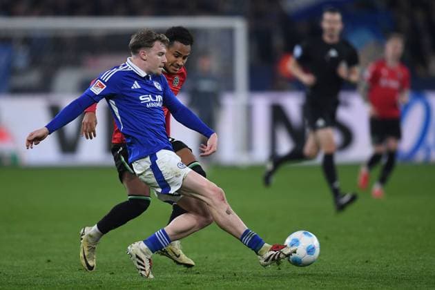 Soccer 2 Bundesliga 26 Matchday FC Schalke 04 Hannover 96 on 14 03 2025 at the Veltins Arena in Gelsenkirchen Derry John Murkin Schalke , front Monju Thaddäus Momuluh Hannover , back DFL regulations prohibit any use of photographs as image sequences and or quasi video xRx