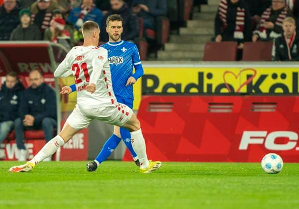 Sergio Lopez SV Darmstadt, 2 is put under pressure by Steffen Tigges 1 FC Koeln, 21 and initiates the 1 0 for 1 FC Köln with his back pass 1 FC Köln SC Darmstadt 98, 15 03 2025 Football, 2 Bundesliga, RheinEnergieStadion Köln DFL regulations prohibit any use of photographs as image sequences and or quasi video Copyright: HMBxMedia xMarcoxBader