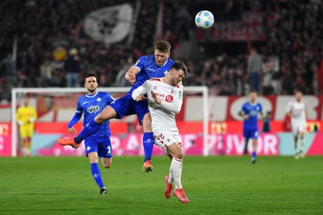 Clemens Riedel SV Darmstadt 98 and Jan Thielmann 1 FC Koeln battle for the ball during the 2 Bundesliga match between 1 FC Köln and SV Darmstadt 98 at RheinEnergieStadion on March 15, 2025 in Cologne, Germany, Germany Photo by Ralf Treese DeFodi Images Clemens Riedel SV Darmstadt 98 and Jan Thielmann 1 FC Koeln battle for the ball during the 2 Bundesliga match between 1 FC Köln and SV Darmstadt 98 at RheinEnergieStadion on March 15, 2025 in Cologne, Germany Photo by Ralf Treese DeFodi Images DFB DFL REGULATIONS PROHIBIT ANY USE OF PHOTOGRAPHS AS IMAGE SEQUENCES AND OR QUASI VIDEO Photo by Ralf Treese DeFodi Images