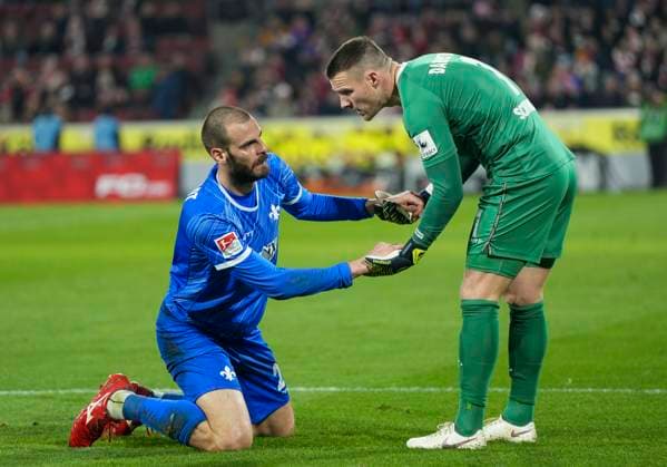 Aleksandar Vukotic SV Darmstadt, 20 lies on the ground after a tackle Marcel Schuhen SV Darmstadt, 1 helps him up 1 FC Köln SC Darmstadt 98, 15 03 2025 Football, 2 Bundesliga, RheinEnergieStadion Köln DFL regulations prohibit any use of photographs as image sequences and or quasi video Copyright: HMBxMedia xMarcoxBader