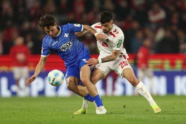 Guille Bueno SV Darmstadt 98 and Jusuf Gazibegovic 1 FC Koeln battle for the ball during the 2 Bundesliga match between 1 FC Köln and SV Darmstadt 98 at RheinEnergieStadion on March 15, 2025 in Cologne, Germany, Germany Photo by Oliver Kaelke DeFodi Images Guille Bueno SV Darmstadt 98 and Jusuf Gazibegovic 1 FC Koeln battle for the ball during the 2 Bundesliga match between 1 FC Köln and SV Darmstadt 98 at RheinEnergieStadion on March 15, 2025 in Cologne, Germany Photo by Oliver Kaelke DeFodi Images DFB DFL REGULATIONS PROHIBIT ANY USE OF PHOTOGRAPHS AS IMAGE SEQUENCES AND OR QUASI VIDEO Photo by Oliver Kaelke DeFodi Images