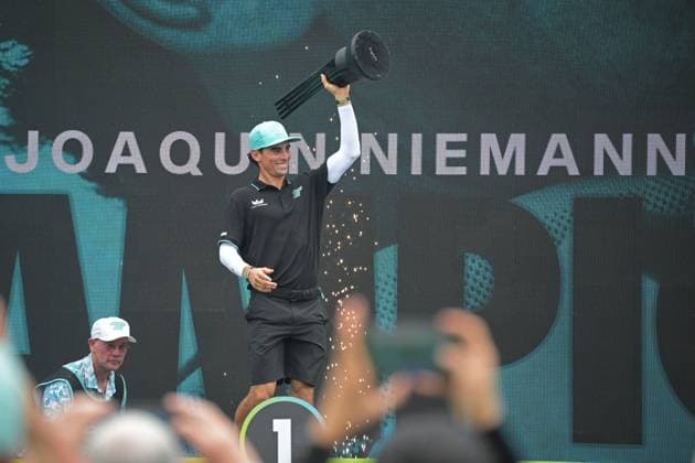 (250316) -- SINGAPORE, March 16, 2025 -- Chile s Joaquin Niemann of Torque GC lifts the trophy on the podium after winning the final round of LIV Golf Singapore held at Sentosa Golf Club in Singapore on March 16, 2025. (Photo by Then Chih Wey Xinhua) (SP)SINGAPORE-GOLF-LIV GOLF-FINAL XinxJiapo 