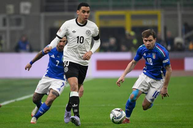 Jamal Musiala of Germany, Matteo Politano and Nicolo Barella of Italy during the UEFA Nations League football match between Italy and Germany at San Siro stadium in Milano (Italy), March 20, 2025. AndreaxStaccioli