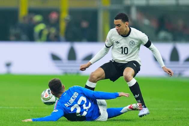 Jamal Musiala (Germany) and Giovanni Di Lorenzo (Italy) battle for the ball, UEFA Nations League Quarterfinal First leg, Italy and Germany, San Siro Stadium, March 20, 2025, Milan, Italy.