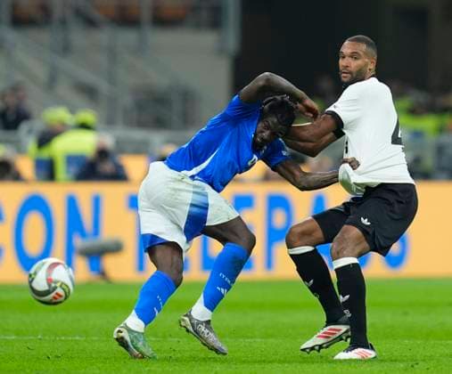Moise Kean (Italy) and Jonathan Tah (Germany) battle for the ball, UEFA Nations League Quarterfinal First leg, Italy and Germany, San Siro Stadium, March 20, 2025, Milan, Italy.