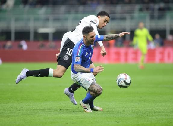 Matteo Politano of Italy and Jamal Musiala of Germany during the UEFA Nations League, Quarter-finals, 1st leg, football match between the national team, Nationalteam of Italy and the national team of Germany, on 20 March 2025, at Giuseppe Meazza stadium, San Siro, Milan, Italy. Photo Nderim Kaceli  Copyright: xNderimxKaceli IPAxSportx xipa-agency.netx xx IPA_55557157 IPA_Agency_IPA55557157