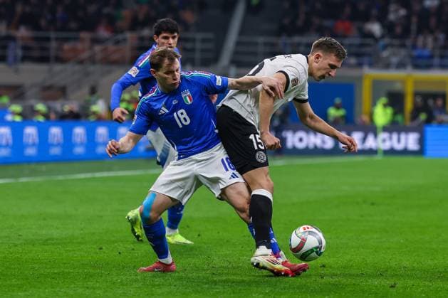 Nicolo Barella of Italy competes for the ball with Nico Schlotterbeck of Germany during UEFA Nations League 2024 25 Quarter-Finals football match between Italy and Germany at San Siro Stadium  Copyright: xFabrizioxCarabelli IPAxSportx xipa-agency.netx xx IPA_55557313 IPA_Agency_IPA55557313