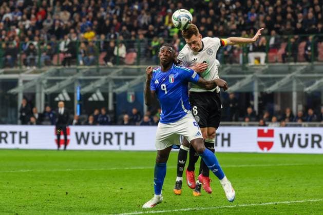 Moise Kean of Italy competes for the ball with Joshua Kimmich of Germany during UEFA Nations League 2024 25 Quarter-Finals football match between Italy and Germany at San Siro Stadium  Copyright: xFabrizioxCarabelli IPAxSportx xipa-agency.netx xx IPA_55557315 IPA_Agency_IPA55557315