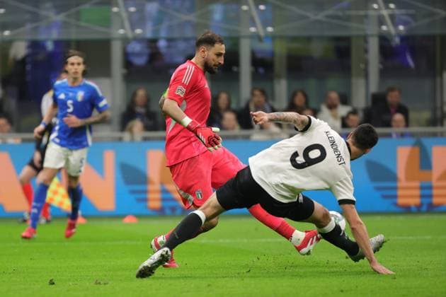 20th March 2025; Stadio San Siro, Milan, Italy, UEFA Nations League Football, Quarter Finals, First Leg, Italy versus Germany; Gianluigi Donnarumma of Italy clears under pressure from Tim Kleindienst of Germany  ActionPlus12763514 EmanuelexPennacchio