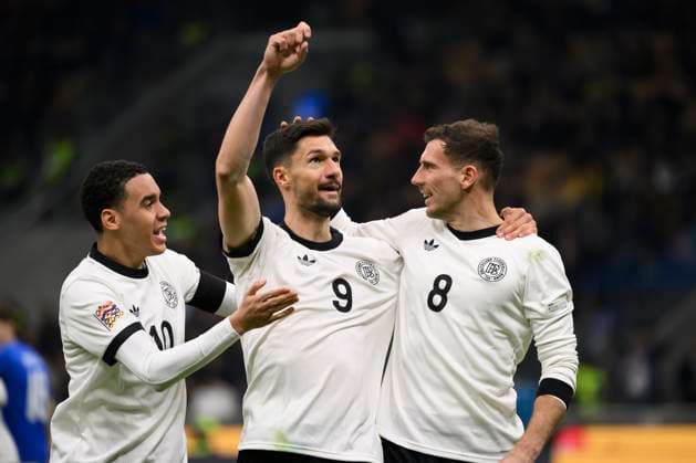 Tim Kleindienst of Germany (c) celebrates with team mates Jamal Musiala and Leon Goretzka after scoring the goal of 1-1 during the UEFA Nations League football match between Italy and Germany at San Siro stadium in Milano (Italy), March 20, 2025. AndreaxStaccioli