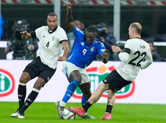 Jonathan Tah (Germany) and Moise Kean (Italy) battle for the ball, UEFA Nations League Quarterfinal First leg, Italy and Germany, San Siro Stadium, March 20, 2025, Milan, Italy.