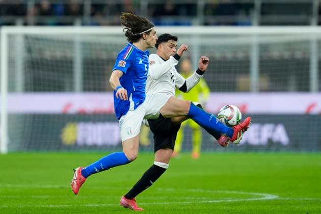 Riccardo Calafiori (Italy) and Nadiem Amiri (Germany) battle for the ball, UEFA Nations League Quarterfinal First leg, Italy and Germany, San Siro Stadium, March 20, 2025, Milan, Italy.