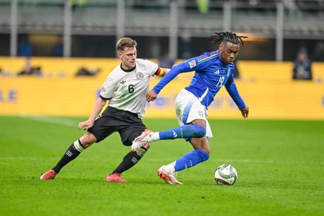 Joshua Kimmich Germany and Destiny Udogie Italy battle for the ball during the UEFA Nations League quarterfinal leg one match between Italy and Germany at Stadio San Siro on March 20, 2025 in Milan, Italy Photo by Harry Langer DeFodi Images