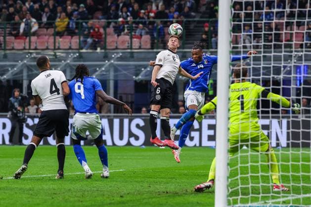CALCIO - UEFA Nations League - Quarter Finals - Italy vs Germany Destiny Udogie of Italy competes for the ball with Joshua Kimmich of Germany during UEFA Nations League 2024 25 Quarter-Finals football match between Italy and Germany at San Siro Stadium Milan Italy  Copyright: xIPAxSport ABACAx