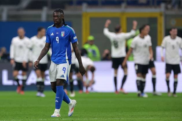 Milan, Italy, 20th March 2025. Moise Kean of Italy reacts as Tim Kleindienst of Germany celebrates in the background with team mates after scoring to give the side a 2-1 lead during the UEFA Nations League match at Giuseppe Meazza, Milan. Picture credit should read: Jonathan Moscrop Sportimage EDITORIAL USE ONLY. No use with unauthorised audio, video, data, fixture lists, club league logos or live services. Online in-match use limited to 120 images, no video emulation. No use in betting, games or single club league player publications. SPI_047_JM_ITALY_GERMANY_UNL_ SPI-3749-0047