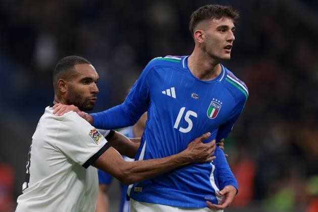 Milan, Italy, 20th March 2025. Jonathan Tah of Germany clashes with Lorenzo Lucca of Italy during the UEFA Nations League match at Giuseppe Meazza, Milan. Picture credit should read: Jonathan Moscrop Sportimage EDITORIAL USE ONLY. No use with unauthorised audio, video, data, fixture lists, club league logos or live services. Online in-match use limited to 120 images, no video emulation. No use in betting, games or single club league player publications. SPI_061_JM_ITALY_GERMANY_UNL_ SPI-3749-0061