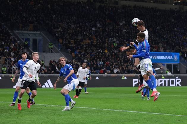 Milan, Italy, 20th March 2025. Leon Goretzka of Germany climbs above Giovanni Di Lorenzo of Italy to head golwards during the UEFA Nations League match at Giuseppe Meazza, Milan. Picture credit should read: Jonathan Moscrop Sportimage EDITORIAL USE ONLY. No use with unauthorised audio, video, data, fixture lists, club league logos or live services. Online in-match use limited to 120 images, no video emulation. No use in betting, games or single club league player publications. SPI_065_JM_ITALY_GERMANY_UNL_ SPI-3749-0065
