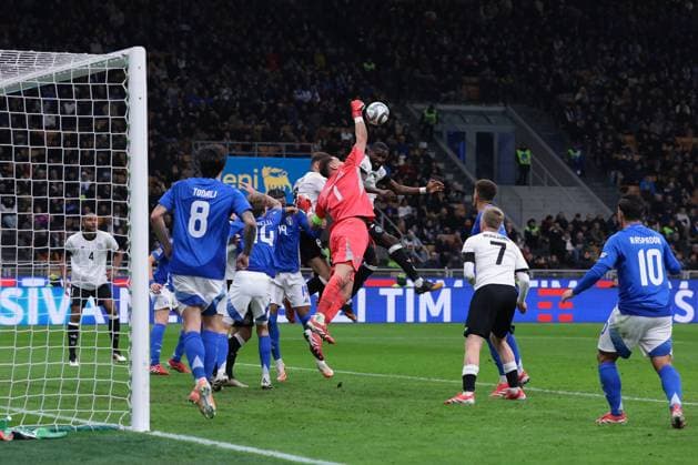 Milan, Italy, 20th March 2025. Gianluigi Donnarumma of Italy punches the ball away from Antonio Rudiger of Germany during the UEFA Nations League match at Giuseppe Meazza, Milan. Picture credit should read: Jonathan Moscrop Sportimage EDITORIAL USE ONLY. No use with unauthorised audio, video, data, fixture lists, club league logos or live services. Online in-match use limited to 120 images, no video emulation. No use in betting, games or single club league player publications. SPI_067_JM_ITALY_GERMANY_UNL_ SPI-3749-0069
