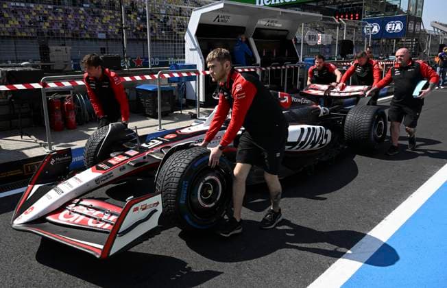 (250321) -- SHANGHAI, March 21, 2025 -- Haas staff members push the car of French driver Esteban Ocon during the first practice session of the Formula 1 Chinese Grand Prix at the Shanghai International Circuit in east China s Shanghai, on March 21, 2025. ) (SP)CHINA-SHANGHAI-FORMULA 1-PRACTICE (CN) HexChangshan 