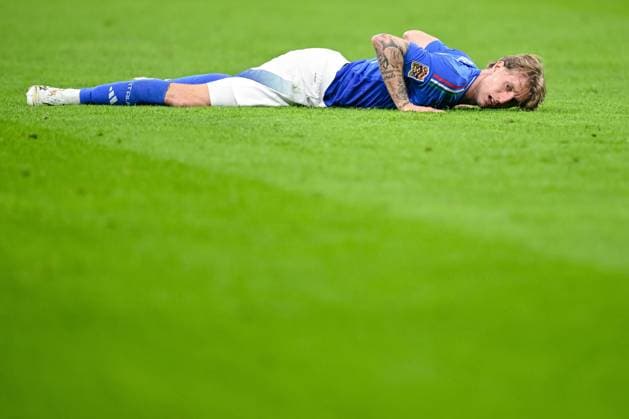 Nicolo Rovella Italy looks dejected on the ground during the UEFA Nations League quarterfinal leg one match between Italy and Germany at Stadio San Siro on March 20, 2025 in Milan, Italy Photo by Harry Langer DeFodi Images