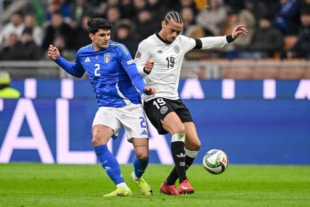 Roul Bellanova Italy and Leroy Sane Germany battle for the ball during the UEFA Nations League quarterfinal leg one match between Italy and Germany at Stadio San Siro on March 20, 2025 in Milan, Italy Photo by Harry Langer DeFodi Images
