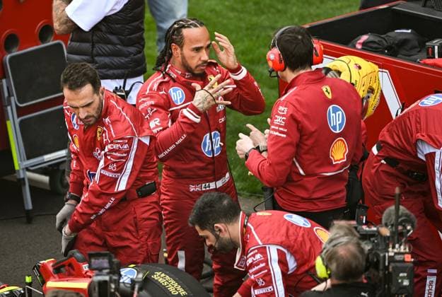 (250322) -- SHANGHAI, March 22, 2025 -- Ferrari s driver Lewis Hamilton (2nd L) of Britain communicates with his team member before the sprint race of the Formula 1 Chinese Grand Prix at the Shanghai International Circuit in east China s Shanghai, March 22, 2025. ) (SP)CHINA-SHANGHAI-FORMULA 1-SPRINT(CN) XiaxYifang 