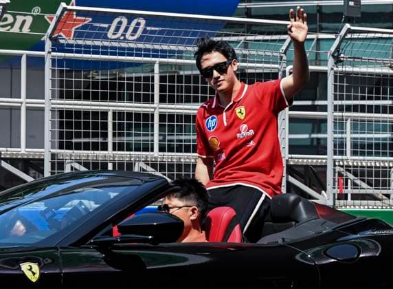 (250323) -- SHANGHAI, March 23, 2025 -- Ferrari s reserve driver Zhou Guanyu of China reacts during the drivers parade of the Formula 1 Chinese Grand Prix at the Shanghai International Circuit in east China s Shanghai, March 22, 2025. ) (SP)CHINA-SHANGHAI-FORMULA 1-DRIVERS PARADE (CN) HexChangshan 