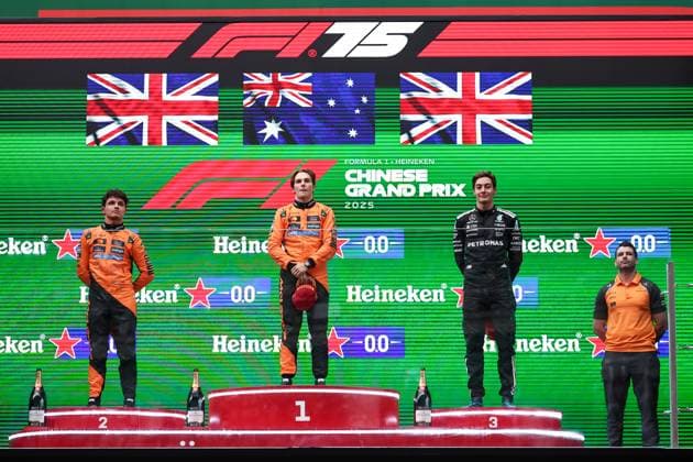 F1 Grand Prix Of China Lando Norris of Great Britain and McLaren, race winner Oscar Piastri of Australia and McLaren, the McLaren trophy delegate, and third-placed George Russell of Great Britain and Mercedes AMG Petronas F1 Team stand on the podium after the F1 Grand Prix of China at Shanghai International Circuit on March 22, 2025, in Shanghai, China. Shanghai Shanghai China  Copyright: xPaddockerx originalFilename:paddocker-f1grandp250323_npVCS.jpg