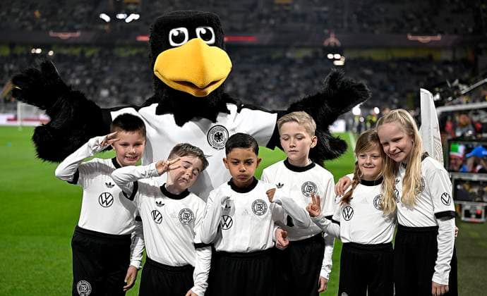 23 03 2025, Football UEFA Nations League 2024 25, quarter-final, Germany Italy, in Dortmund, Signal Iduna Stadium, DFB mascot Paule and the run-in children