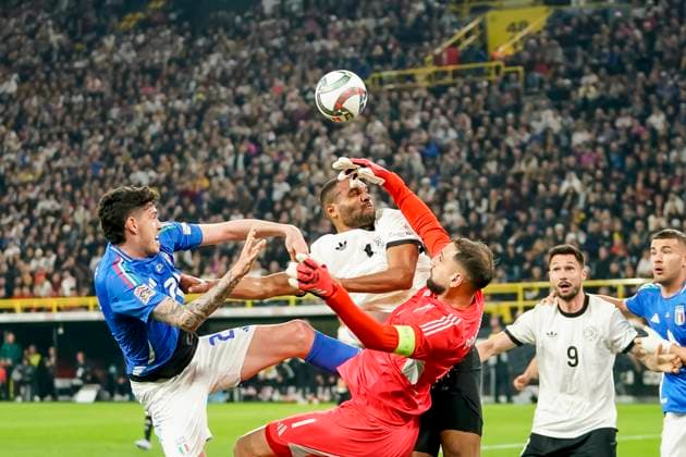 Giovanni Di Lorenzo Italy , Jonathan Tah Germany and goalkeeper Gianluigi Donnarumma Italy battle for the ball during the UEFA Nations League Quarterfinal Leg Two match between Germany and Italy at Football Stadium Dortmund on March 23, 2025 in Dortmund, Germany