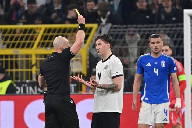 23 03 2025, xjrdrx, Football UEFA Nations League, Germany Italy v l Referee Referee Szymon Marciniak Poland shows Angelo Stiller German National Football Team DFB the yellow card DFL DFB REGULATIONS PROHIBIT ANY USE OF PHOTOGRAPHS as IMAGE SEQUENCES and or QUASI VIDEO Dortmund