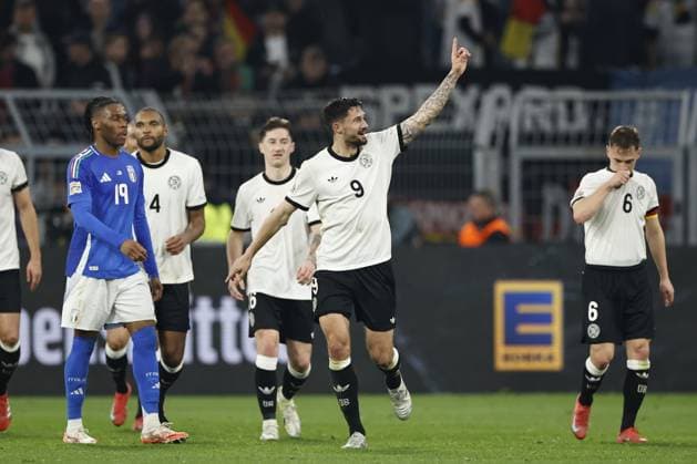 DORTMUND - (l-r) Destiny Udogie of Italy balks, Tim Kleindienst of Germany celebrates the 3-0 during the UEFA Nations League quarterfinal match between Germany and Italy at the BVB Stadion Dortmund on March 23, 2025 in Dortmund, Germany. ANP Hollandse Hoogte MAURICE VAN STEEN UEFA Nations League Quarterfinal Leg Two 2025 xVIxANPxSportx xMauricexvanxSteenxIVx 522969673 originalFilename: 522969673.jpg