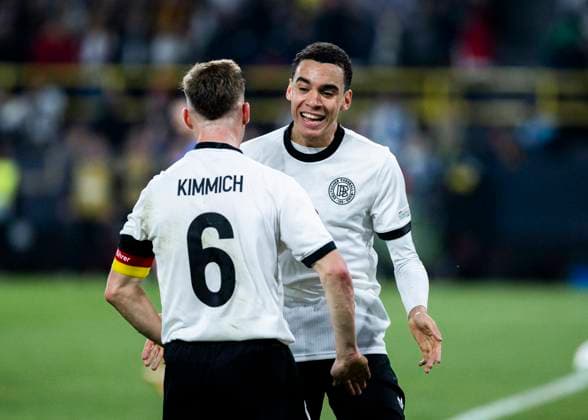 Signal Iduna Park, Dortmund, 23 03 2025 Jamal Musiala of Germany R celebrates scoring the 2 0 goal with Joshua Kimmich of Germany during the UEFA Nations League Quarterfinal Match Germany v Italia