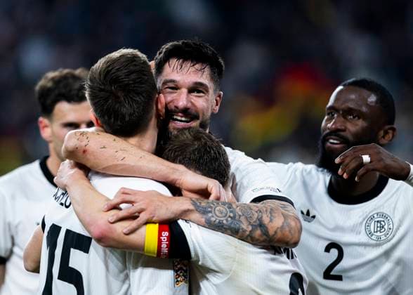 Signal Iduna Park, Dortmund, 23 03 2025 Tim Kleindienst of Germany celebrates scoring the 3 0 goal with Nico Schlotterbeck of Germany and Joshua Kimmich of Germany during the UEFA Nations League Quarterfinal Match Germany v Italia