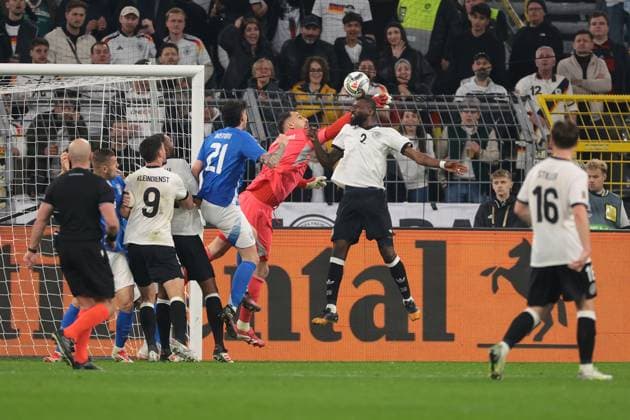 Dortmund, Germany, 23rd March 2025. Gianluigi Donnarumma of Italy pushes the ball away from Antonio Rudiger of Germany during the UEFA Nations League match Germany vs Italy at BVB Stadion, Dortmund. Picture credit should read: Jonathan Moscrop Sportimage EDITORIAL USE ONLY. No use with unauthorised audio, video, data, fixture lists, club league logos or live services. Online in-match use limited to 120 images, no video emulation. No use in betting, games or single club league player publications. SPI_015_JM_GERMANY_ITALY_UNL_ SPI-3750-0015