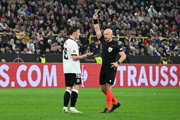23 03 2025, xsltx, Football UEFA Nations League, Germany Italy v l Angelo Stiller German National Football Team DFB Referee Referee Szymon Marciniak Poland shows yellow card DFL DFB REGULATIONS PROHIBIT ANY USE OF PHOTOGRAPHS as IMAGE SEQUENCES and or QUASI VIDEO Dortmund
