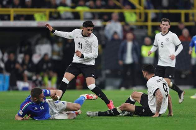 Alessandro Buongiorno Italy , Nadiem Amiri Germany and Tim Kleindienst Germany battle for the ball during the UEFA Nations League Quarterfinal Leg Two match between Germany and Italy at Football Stadium Dortmund on March 23, 2025 in Dortmund, Germany Photo by Oliver Kaelke DeFodi Images