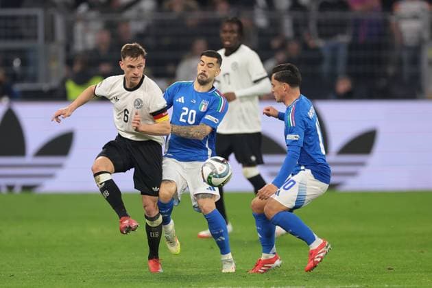 Dortmund, Germany, 23rd March 2025. Giacomo Raspadori of Italy looks on as team mate Mattia Zaccagni clashes with Joshua Kimmich of Germany during the UEFA Nations League match Germany vs Italy at BVB Stadion, Dortmund. Picture credit should read: Jonathan Moscrop Sportimage EDITORIAL USE ONLY. No use with unauthorised audio, video, data, fixture lists, club league logos or live services. Online in-match use limited to 120 images, no video emulation. No use in betting, games or single club league player publications. SPI_058_JM_GERMANY_ITALY_UNL_ SPI-3750-0058